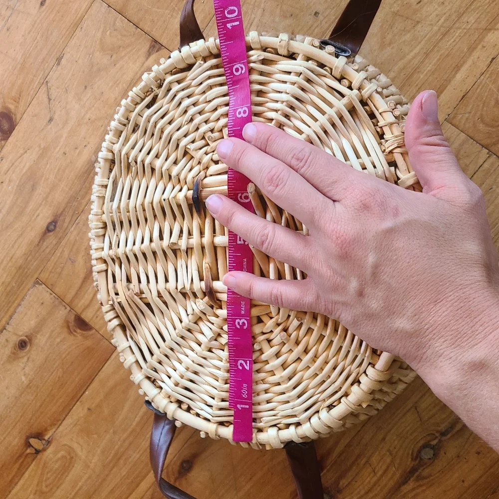 Woven wicker basket with faux leather handles